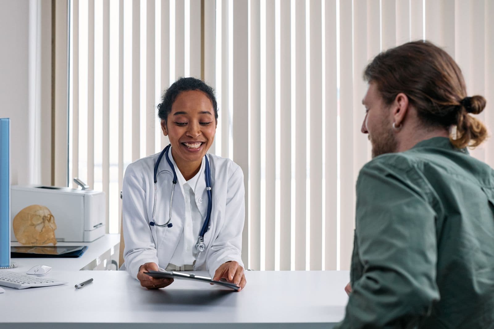 A doctor going over results with a patient in a clinic