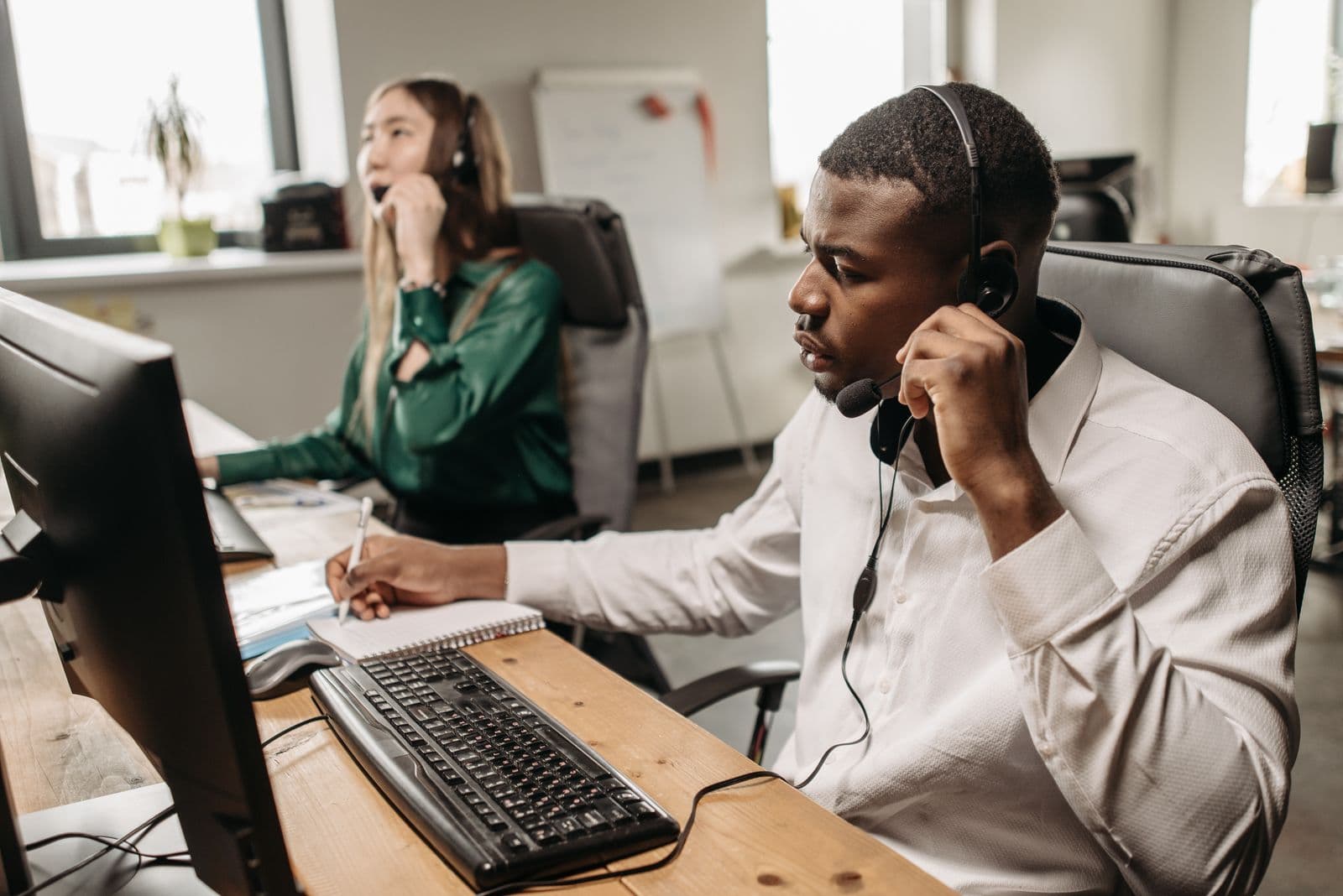 A team of agents with headsets answering calls at their computers