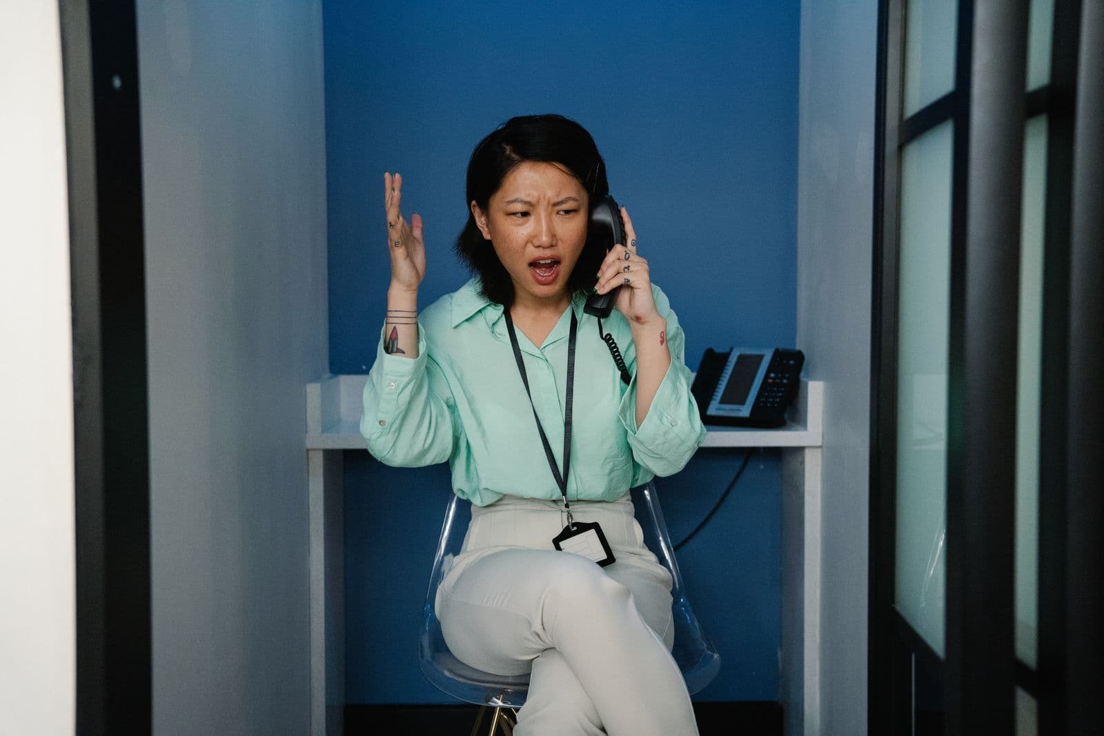 A frustrated woman on the phone at her workplace