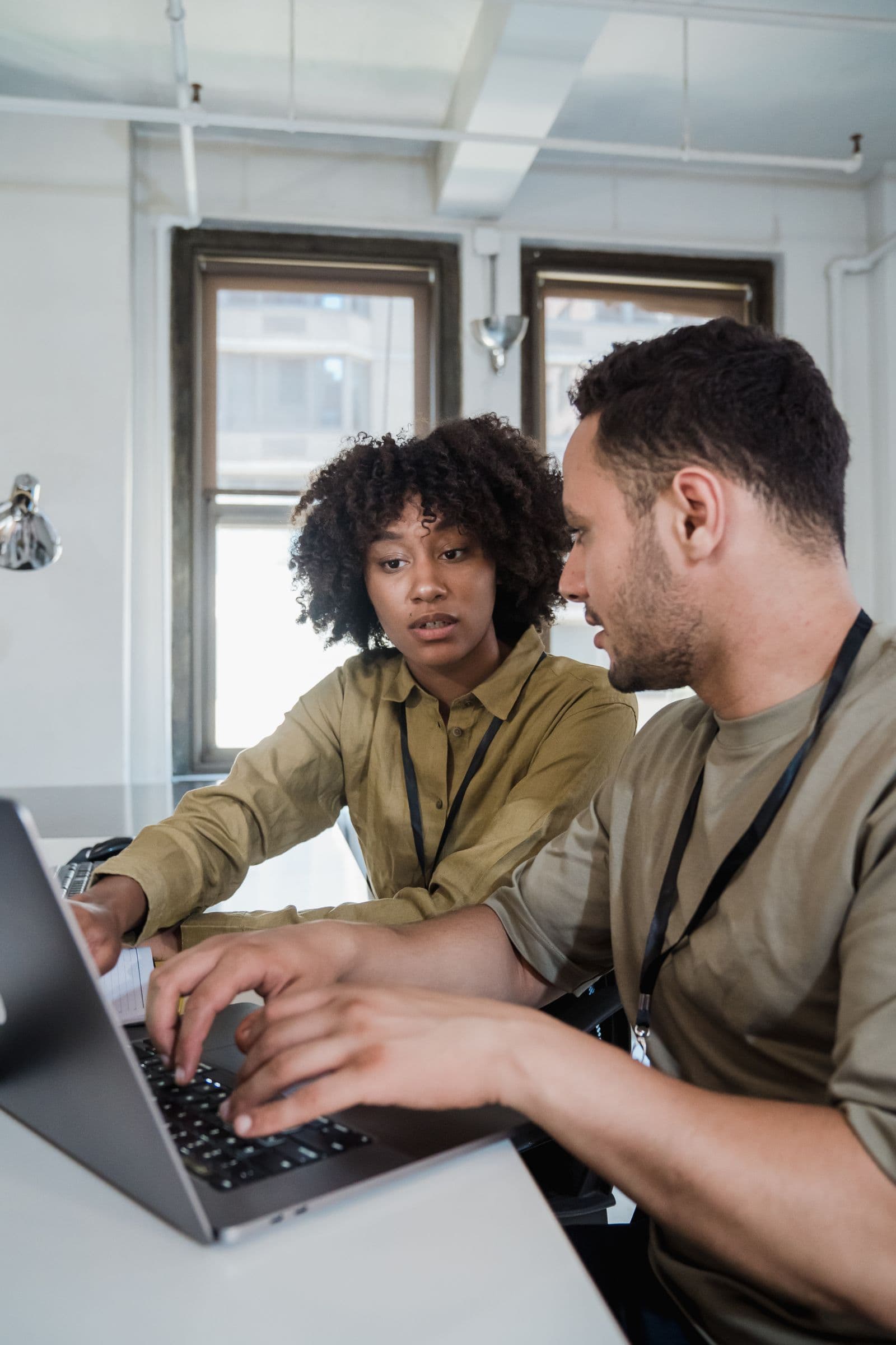 Two colleagues reviewing a draft on a laptop together