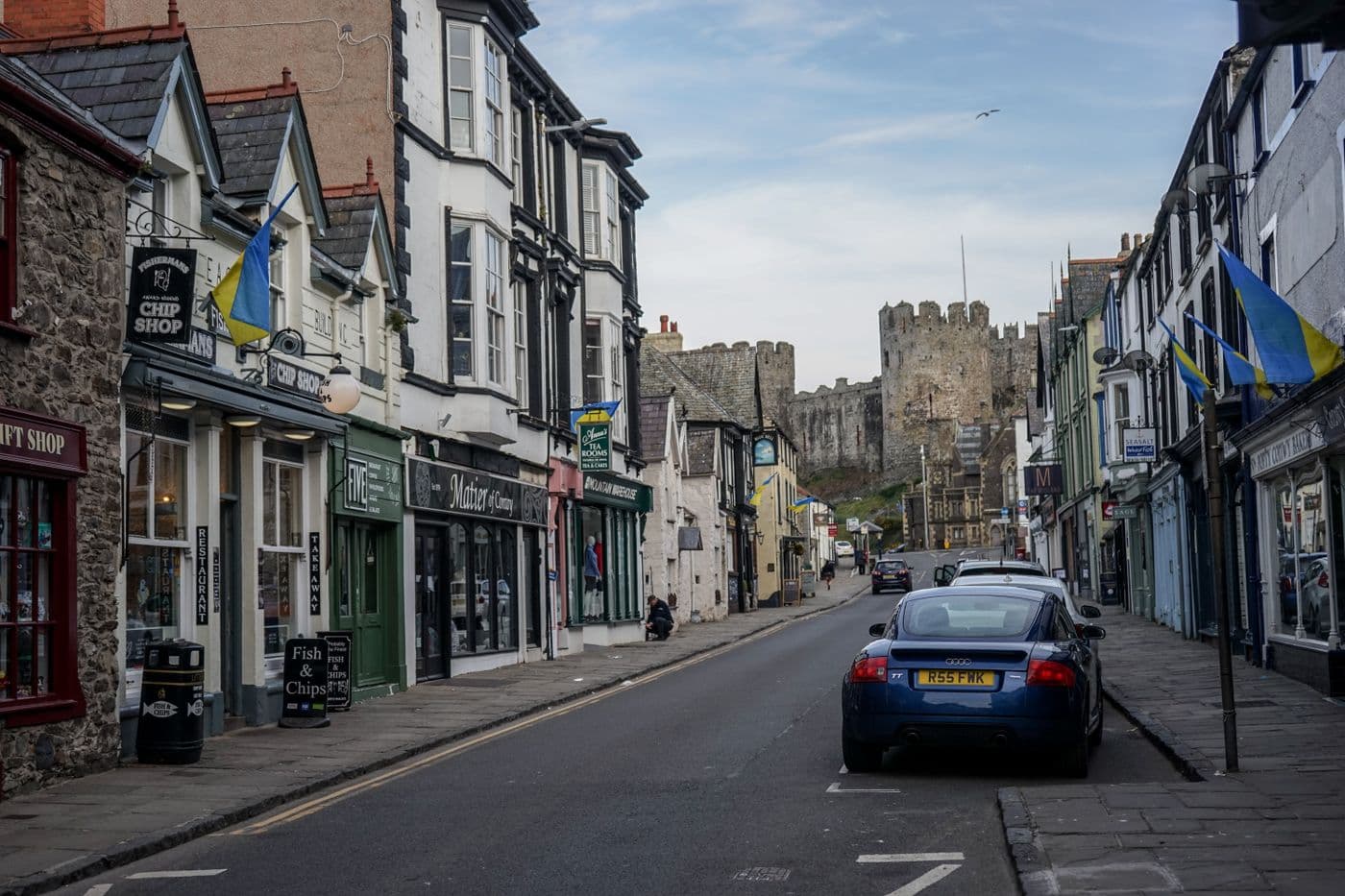 A street in Conwy, Wales, with the castle walls behind
