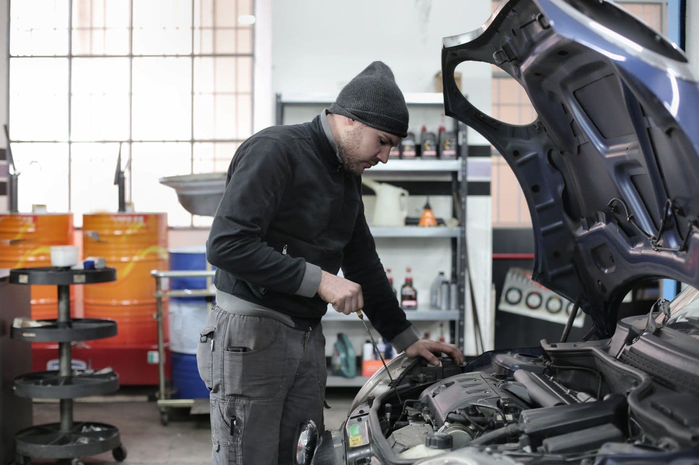 A mechanic working on a car engine in a garage