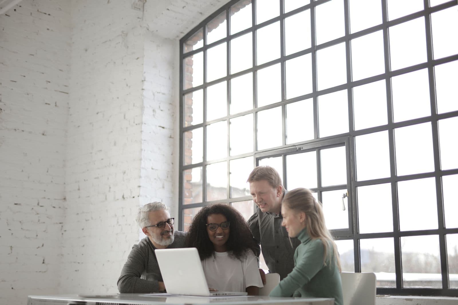 A small team working together around a laptop