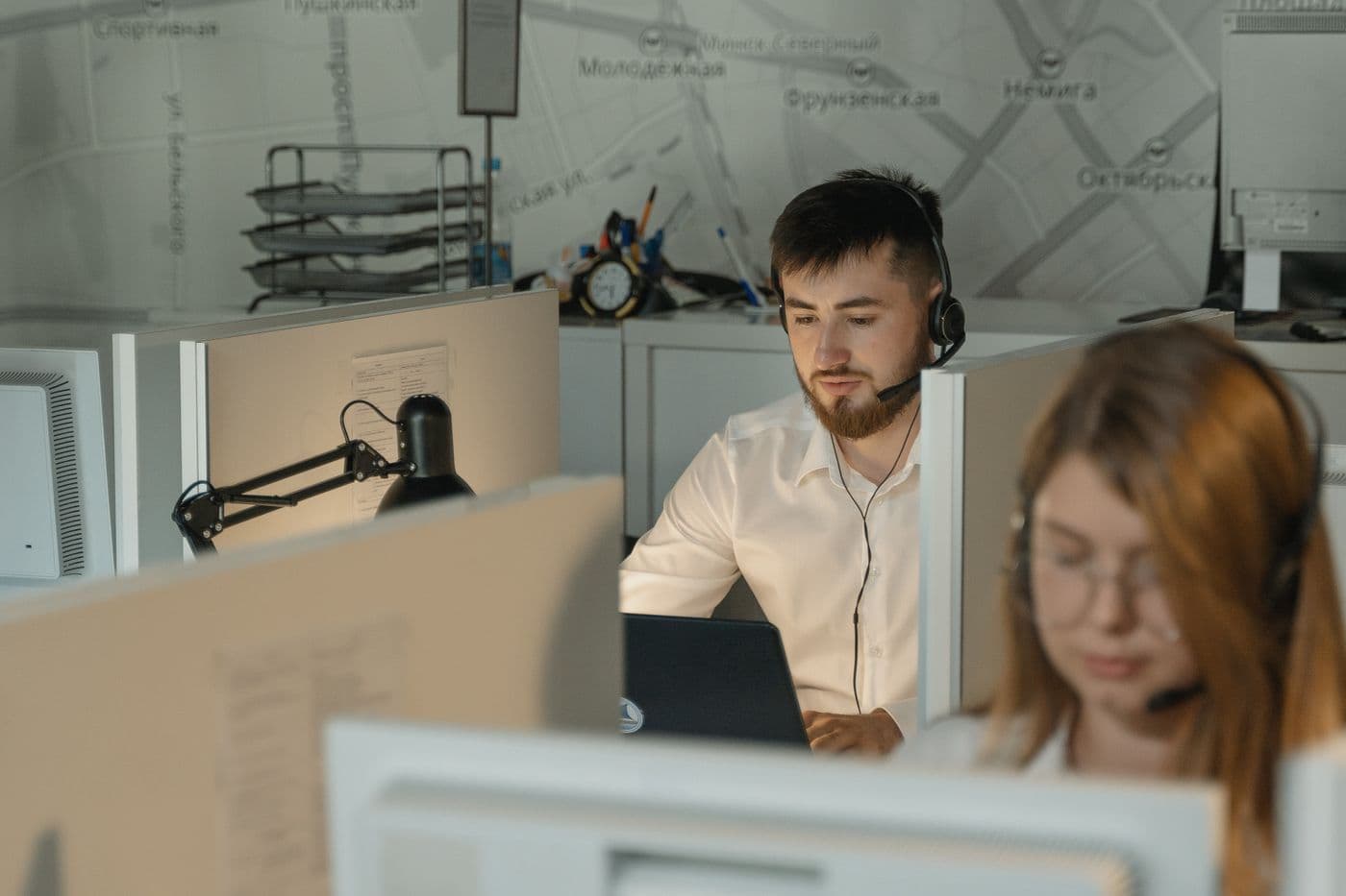 Contact centre agents with headsets working at their desks