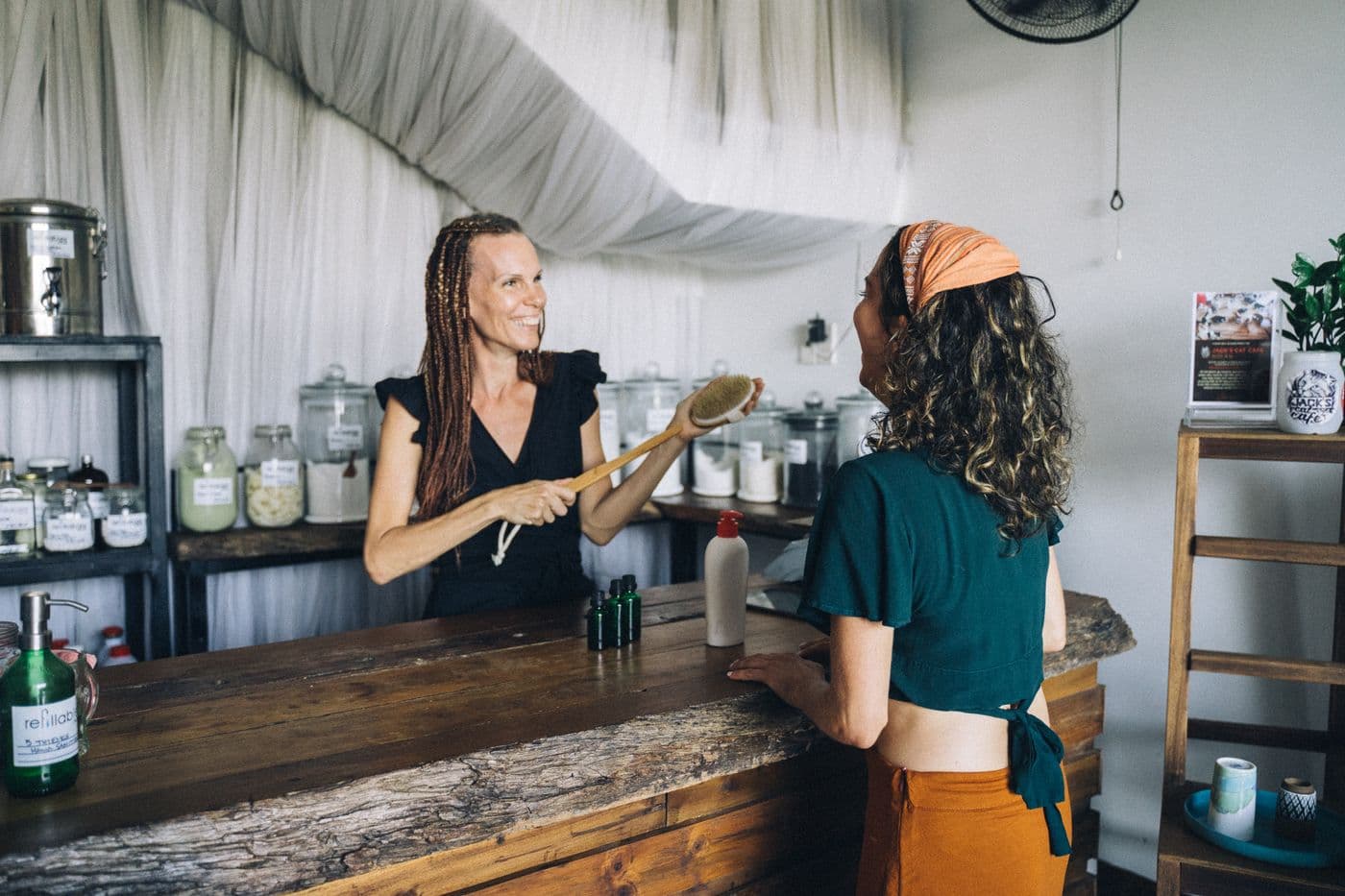 A customer buying from a shop owner at the counter